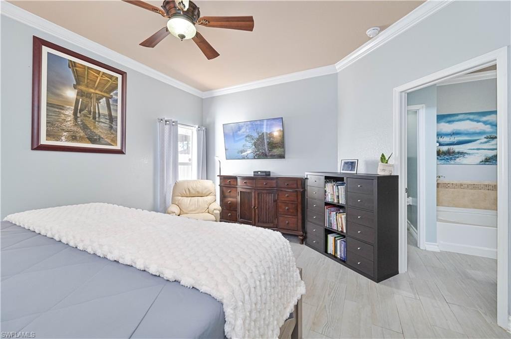 Bedroom with ornamental molding and a ceiling fan
