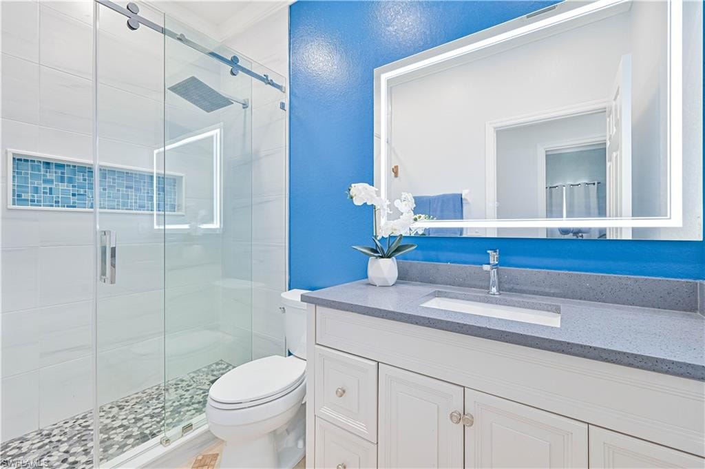 Full bathroom featuring a stall shower and vanity