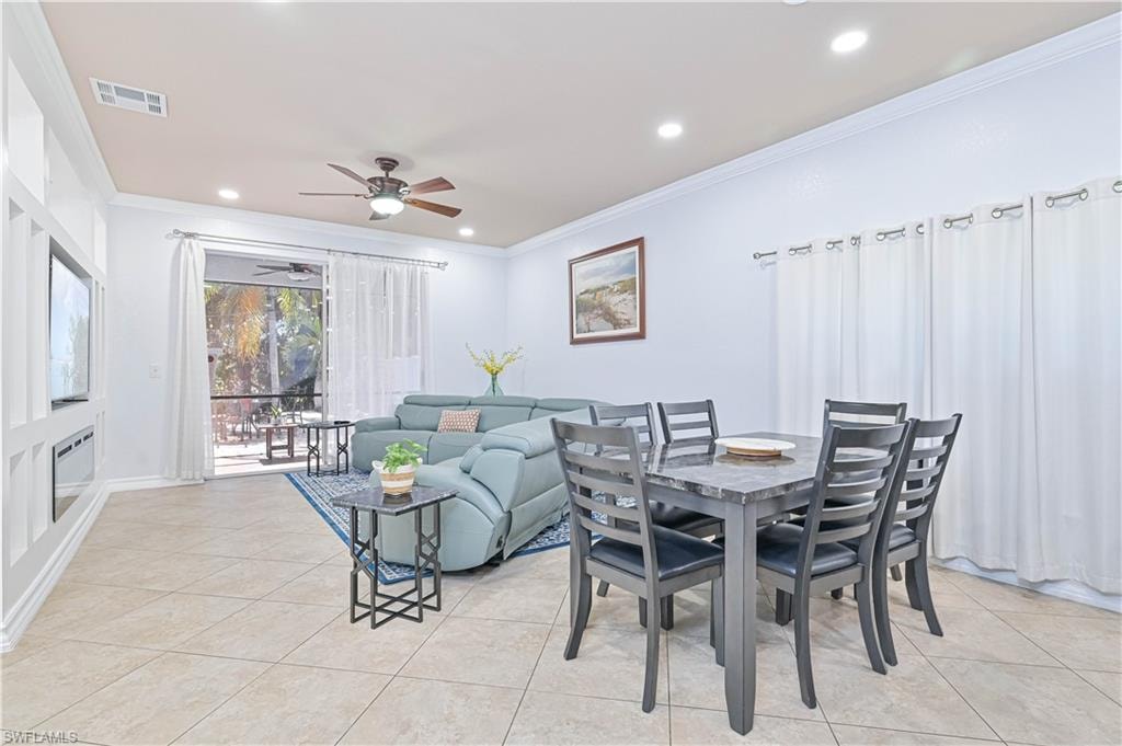 Dining room featuring crown molding, ceiling fan, recessed lighting, and light tile patterned flooring