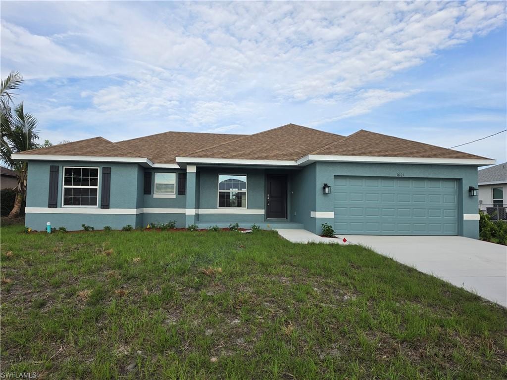 Contemporary exterior featuring a textured stucco finish, dark brown shingle roof, and a two-car garage with a matching teal door