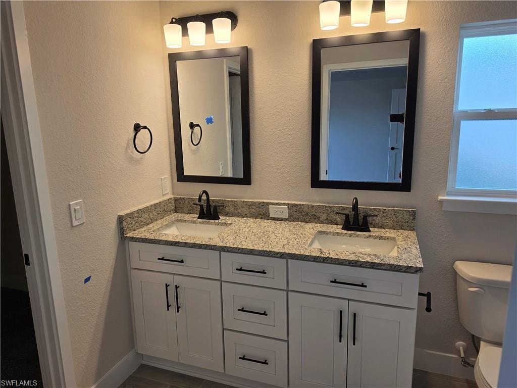 Dual vanity with light-toned countertop and integrated sinks