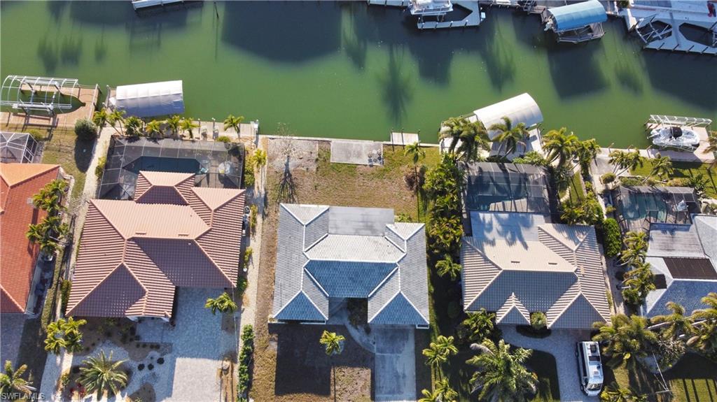 Aerial perspective of suburban area featuring a nearby body of water