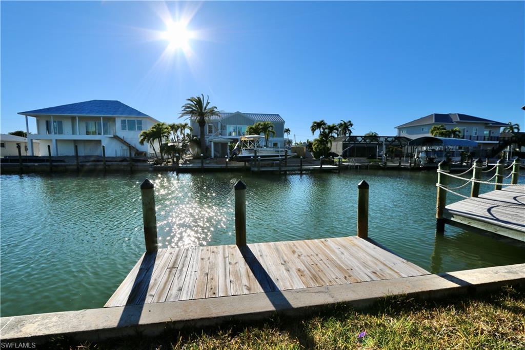 Dock area with a water view and a residential view