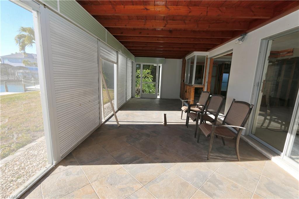 Sunroom / solarium featuring a patio and a water view