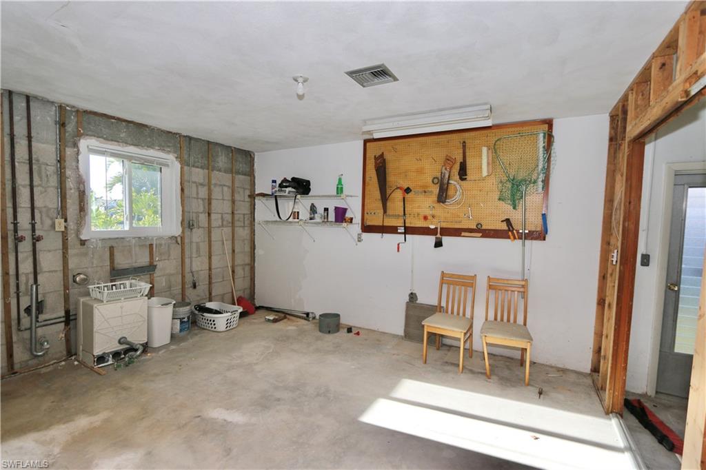 Miscellaneous room with unfinished concrete flooring