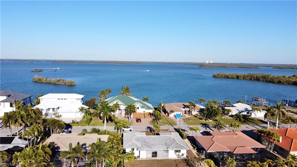 Aerial view of residential area featuring a large body of water