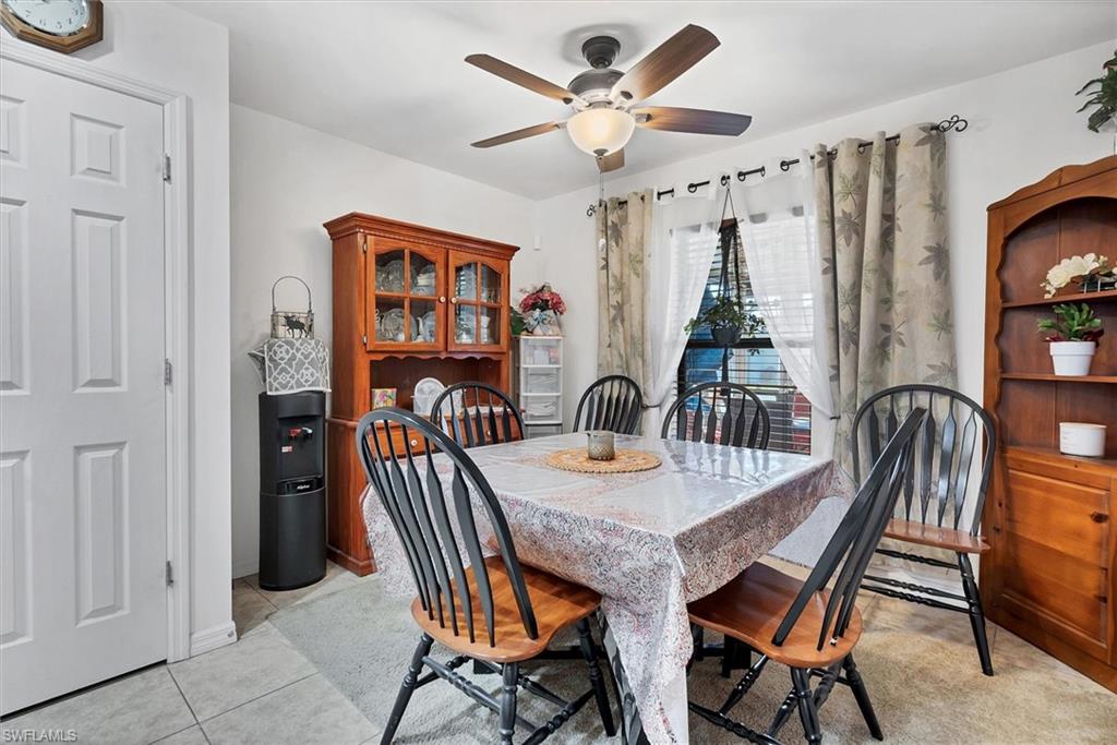 Dining area featuring a ceiling fan and light tile patterned floors