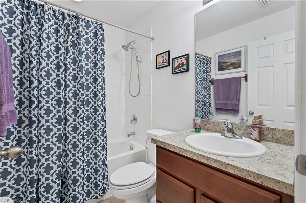 Bathroom featuring vanity and shower / tub combo