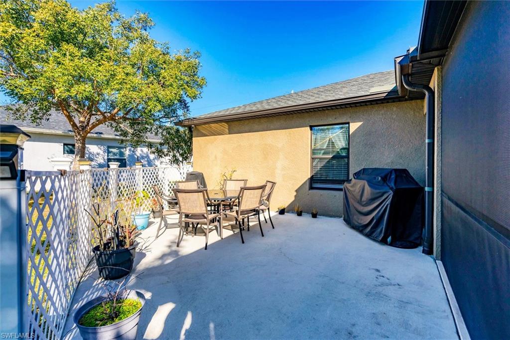 View of patio with outdoor dining area and grilling area