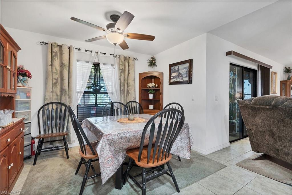 Dining room with ceiling fan and light tile patterned floors