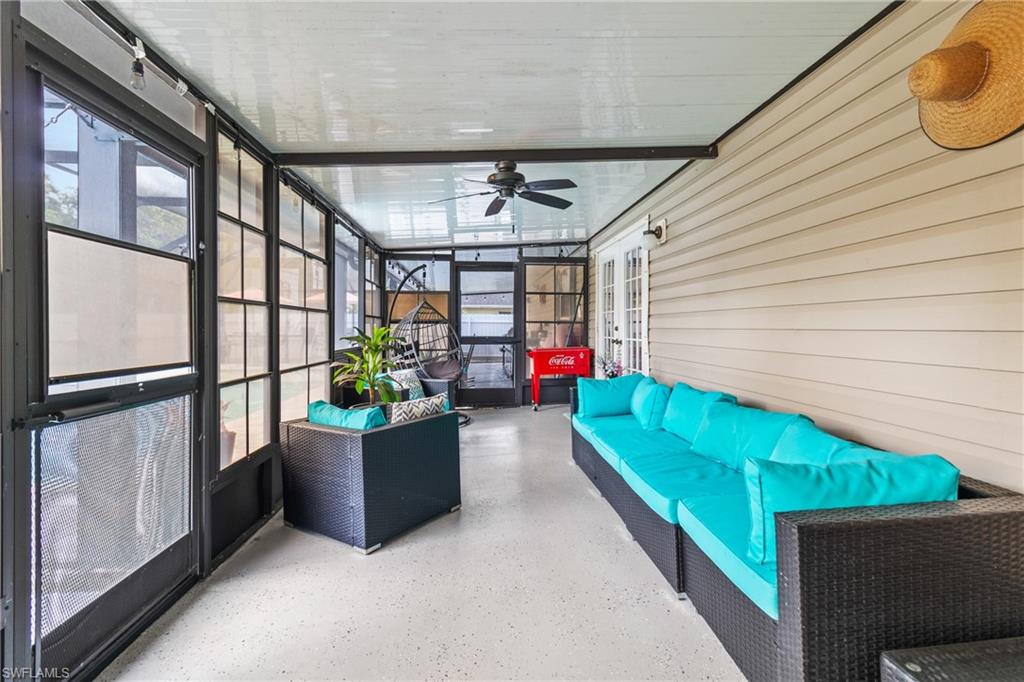 View of patio with exterior kitchen and a sunroom
