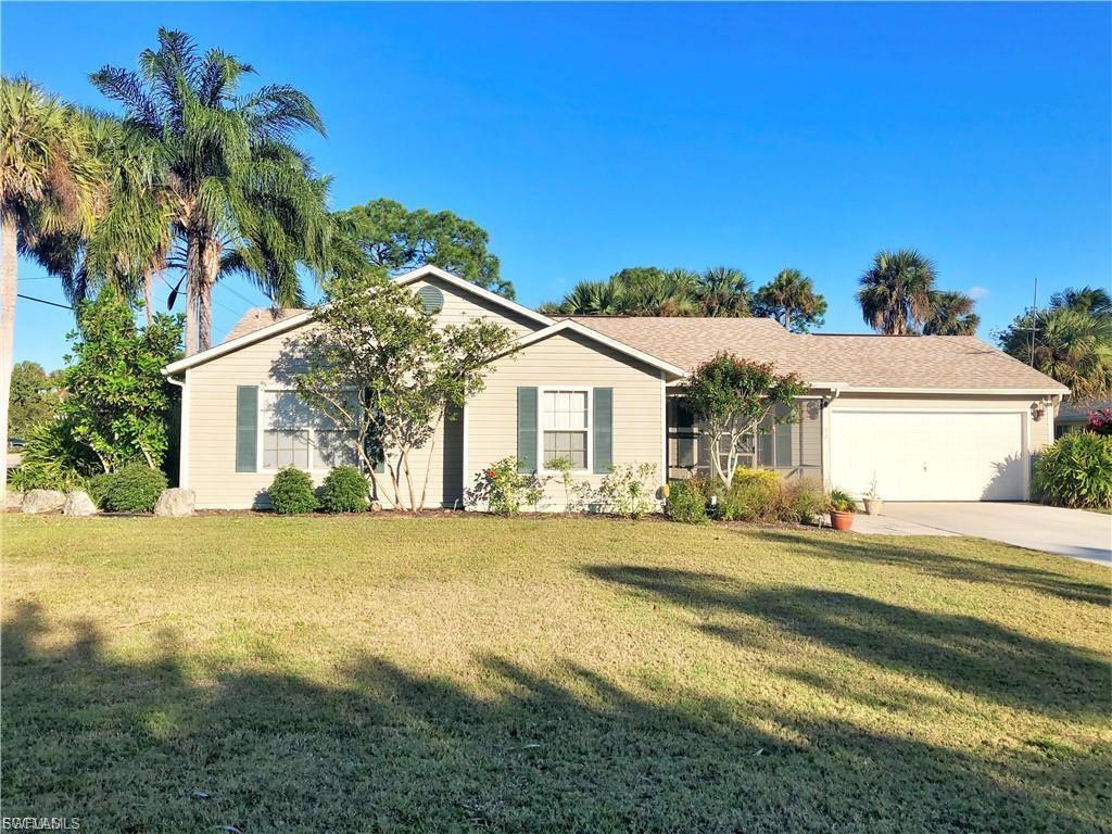 Ranch-style house with an attached garage, a front yard, and concrete driveway