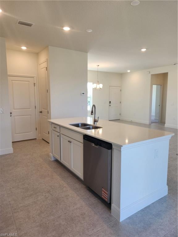 Kitchen with a kitchen island with sink, hanging lights, dishwashing machine, and light tile patterned flooring
