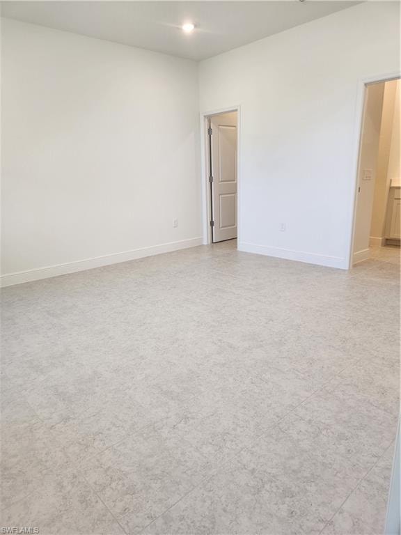 Empty room featuring baseboards