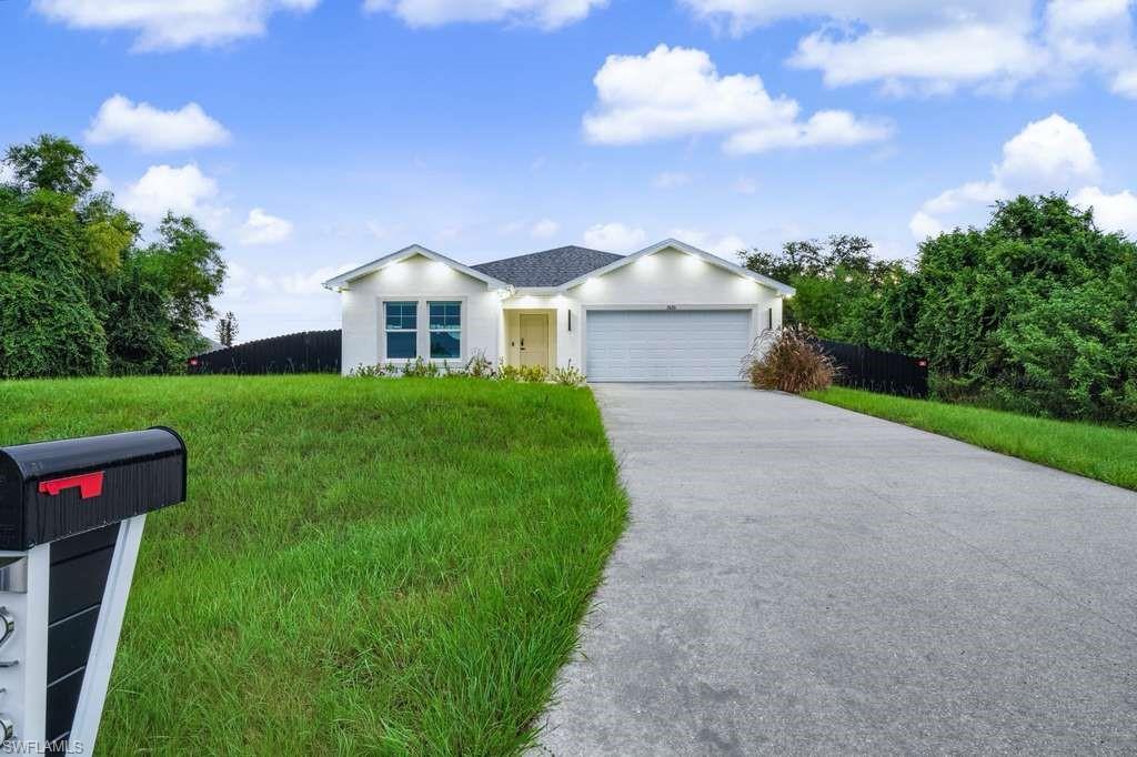 Ranch-style home with stucco siding, concrete driveway, and an attached garage