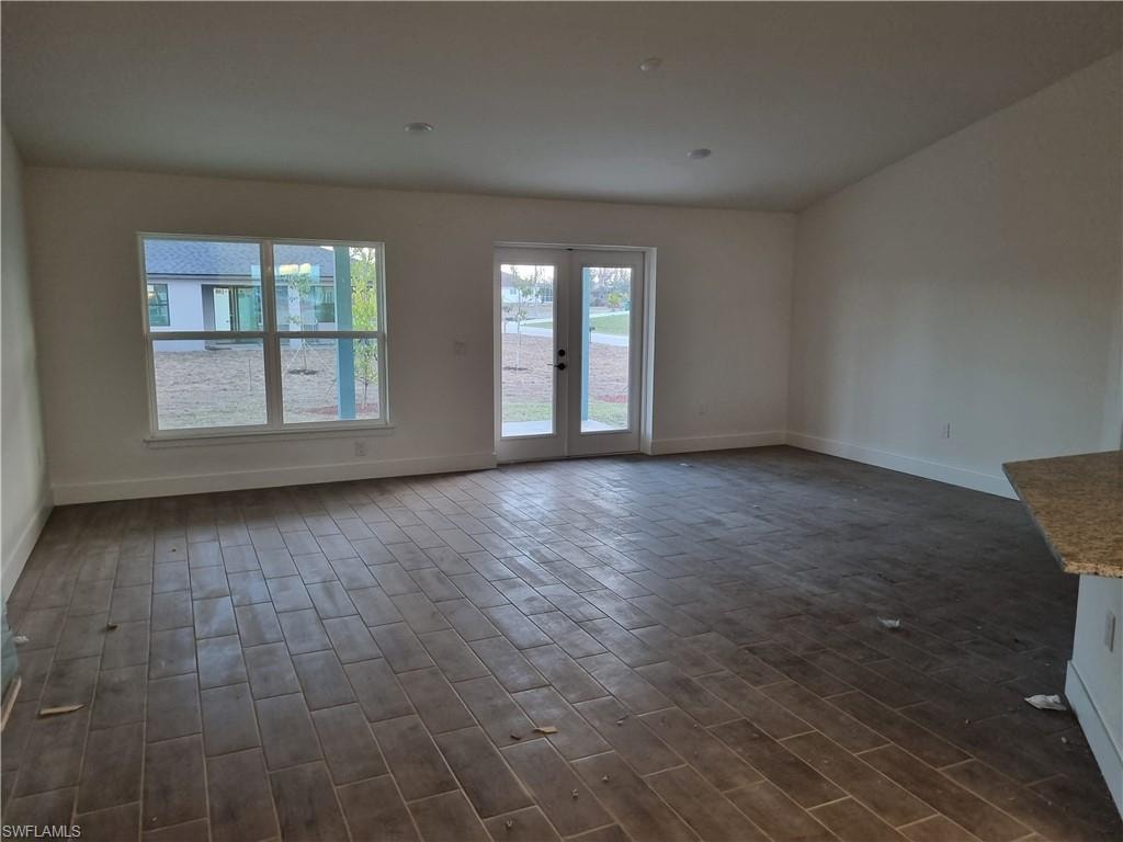 Spare room featuring wood tiled floors and french doors