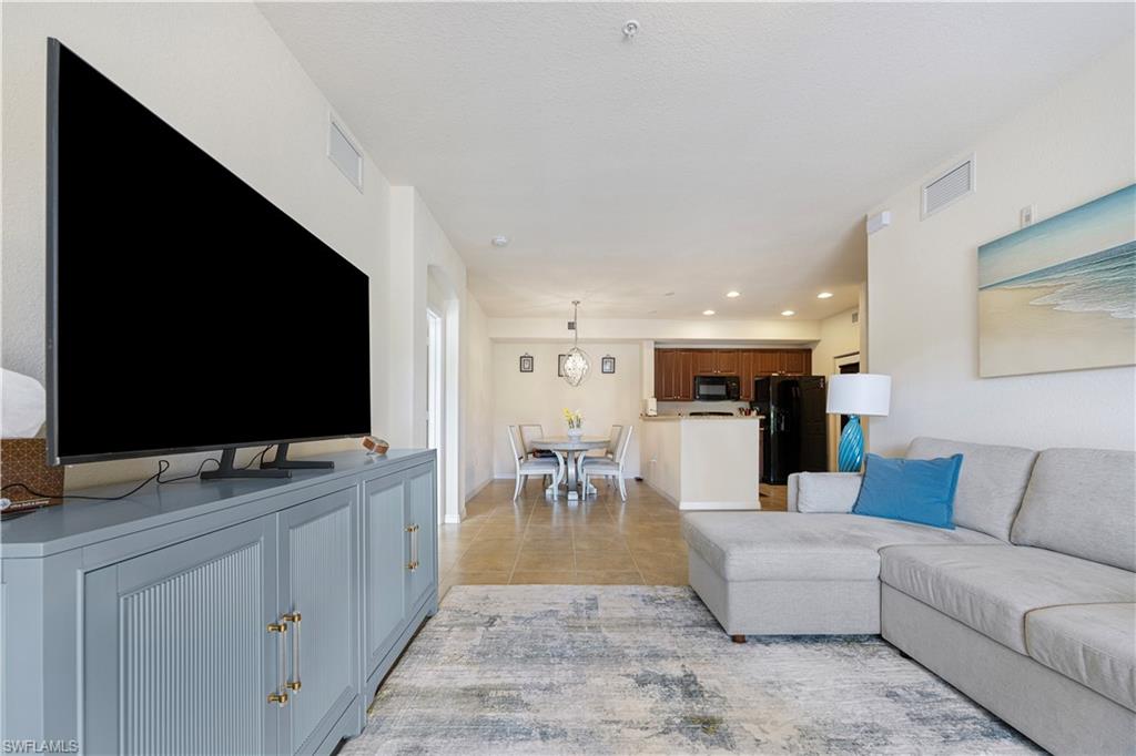 Living area featuring light tile patterned floors and recessed lighting