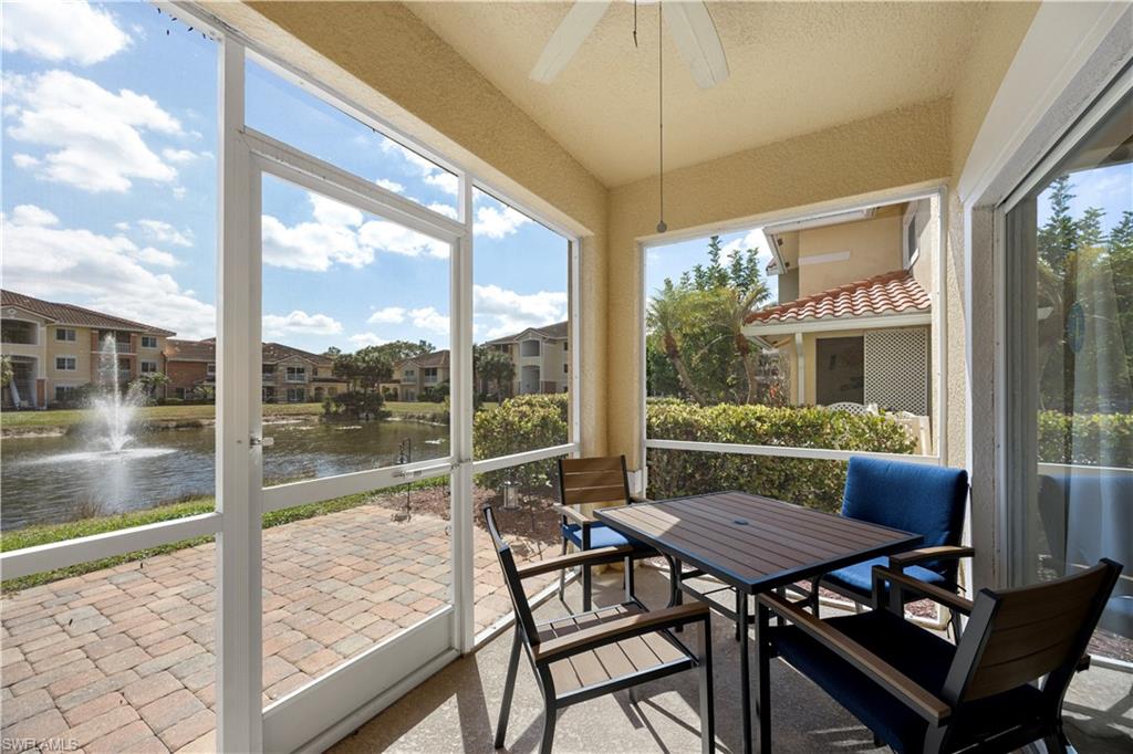 Sunroom with a water view, outdoor dining area, and ceiling fan