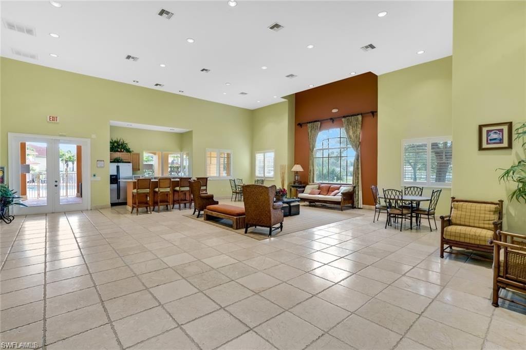 Common area with a high ceiling and recessed lighting