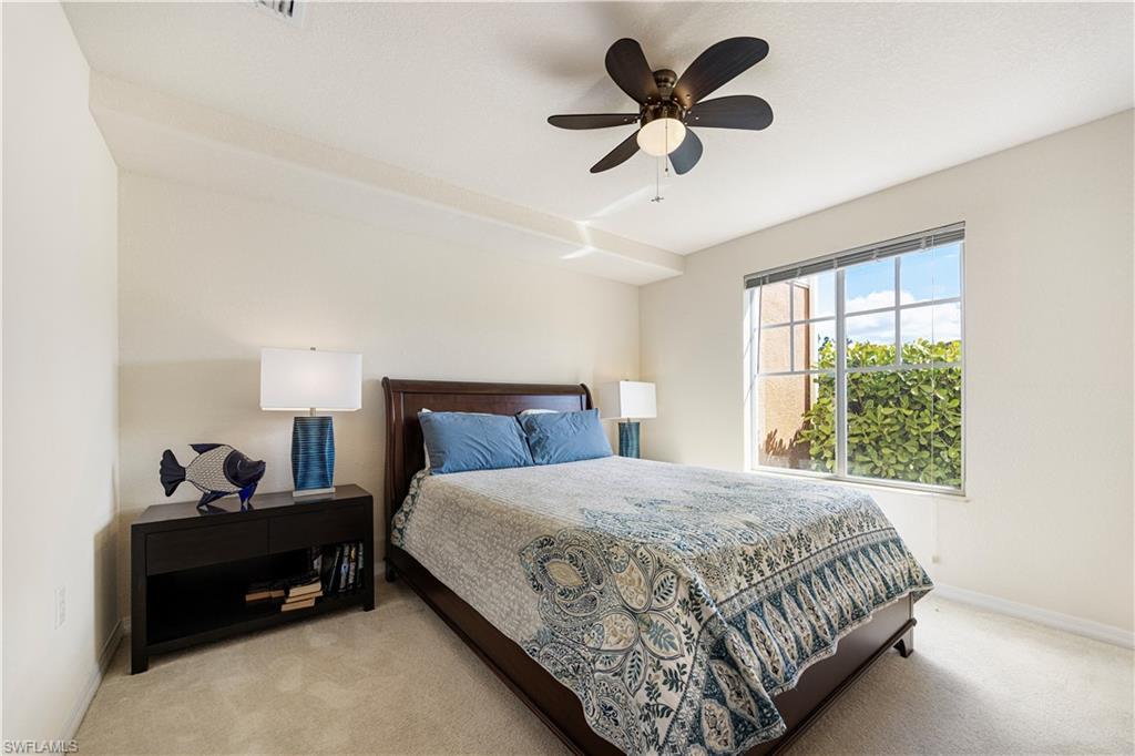 Bedroom featuring light colored carpet and ceiling fan