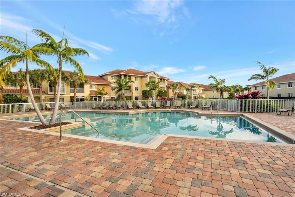 Community pool with a patio and a residential view