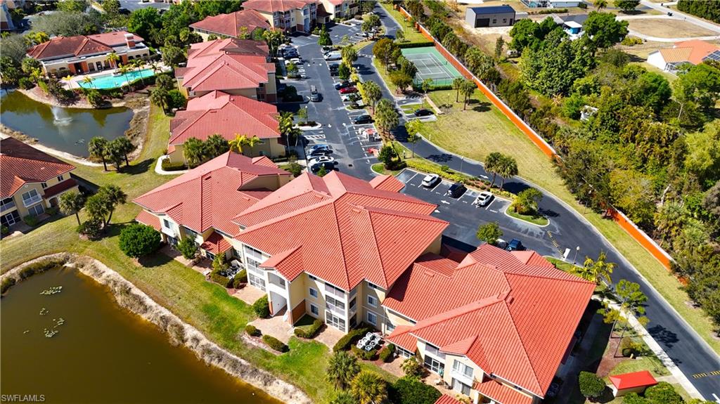 Aerial view of property and surrounding area featuring a large body of water and nearby suburban area