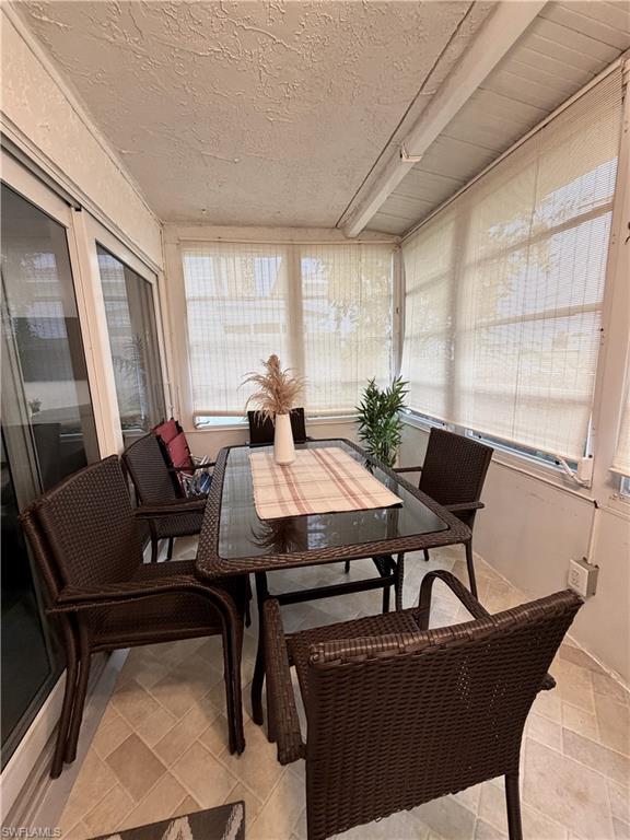 Enclosed lanai large eating area overlooking the golf course and water feature. Blinds for privacy at night.