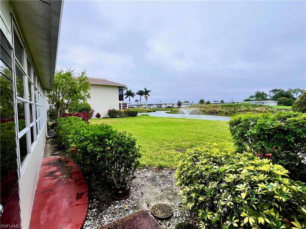 Exterior door from the enclosed lanai steps out to the courtyard area behind the unit.