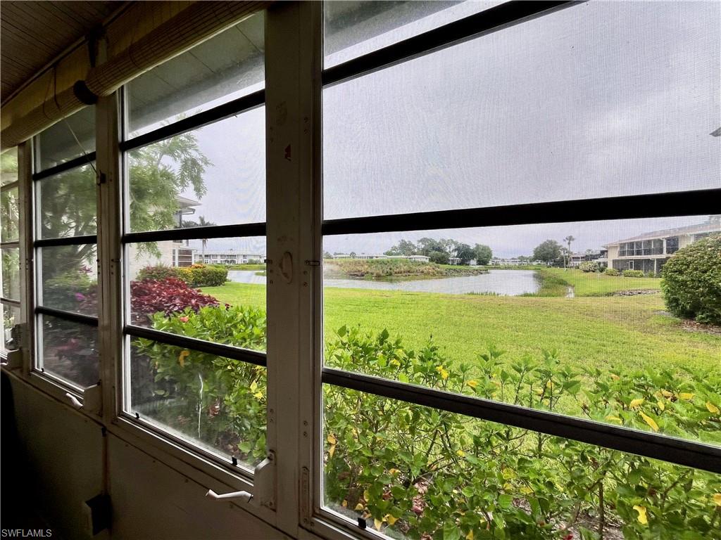View of the golf course and water feature from the lanai when all blinds are opened up.