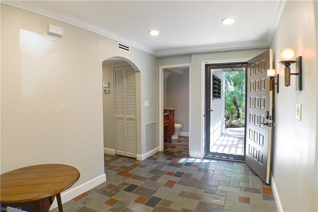 Doorway to property featuring a patio area and stucco siding