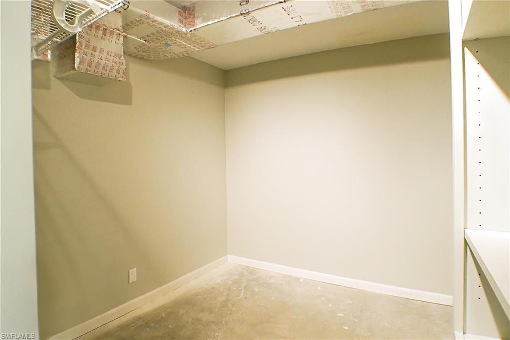 Corridor with crown molding and dark stone finish flooring