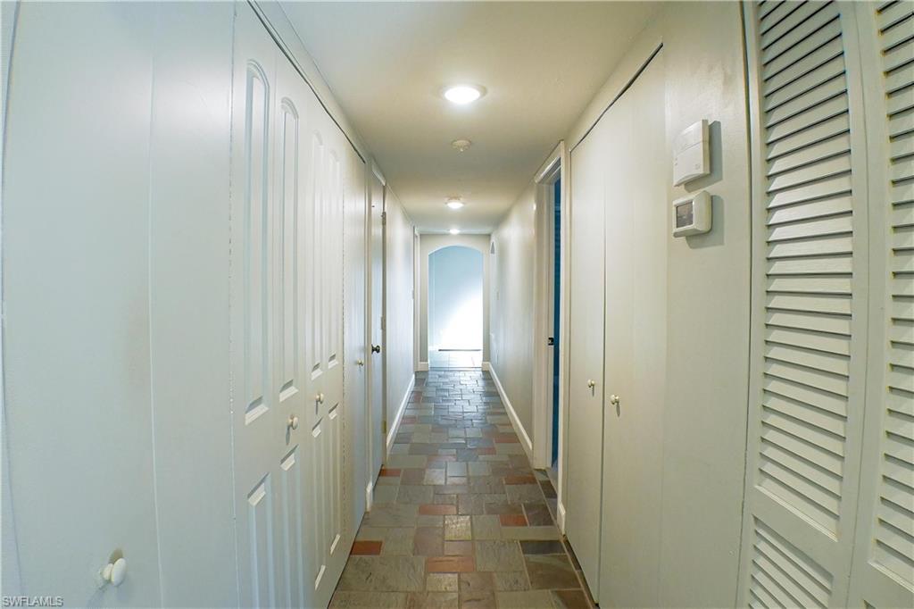 Carpeted spare room featuring built in features, ceiling fan, and a desk