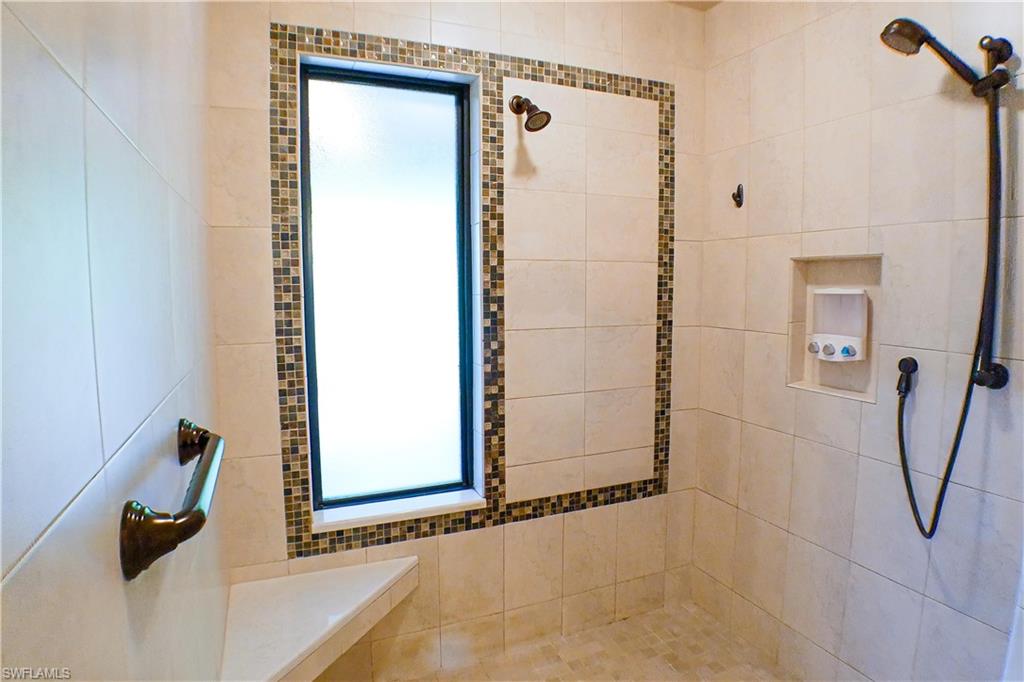 Walk in closet with light tile patterned floors