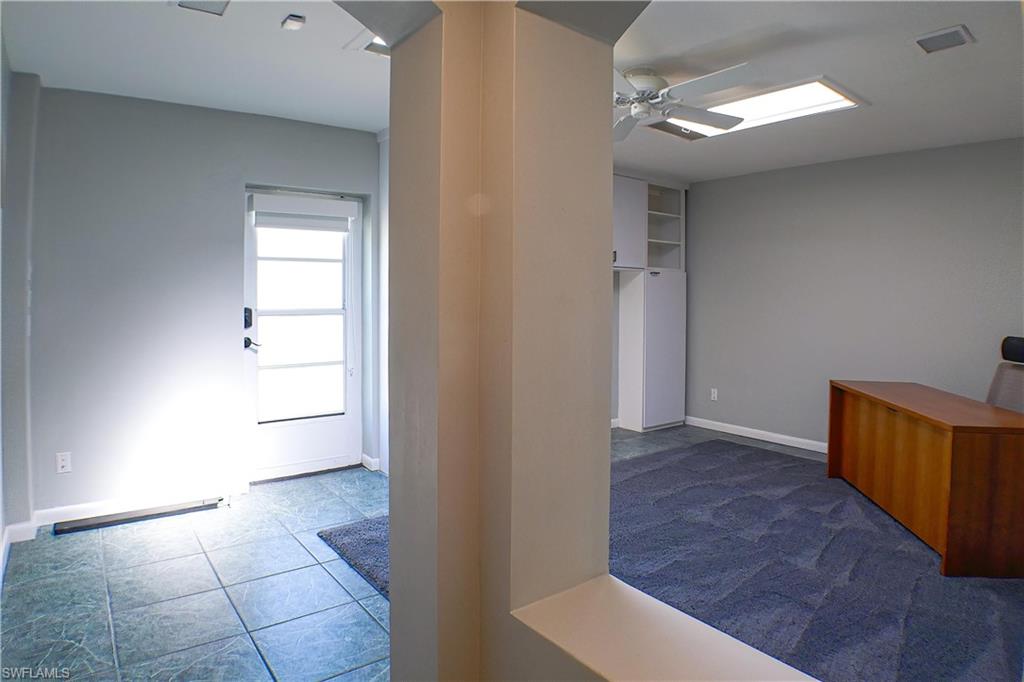 Bathroom with tile patterned floors, a wainscoted wall, and tile walls