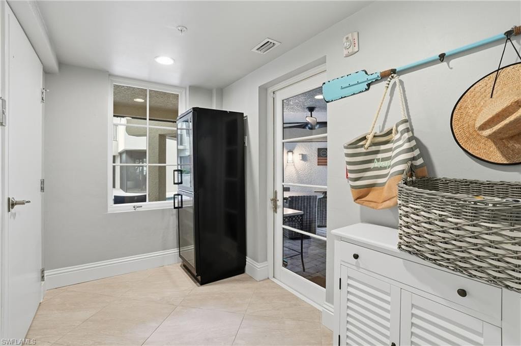 Mudroom with baseboards and light tile patterned floors