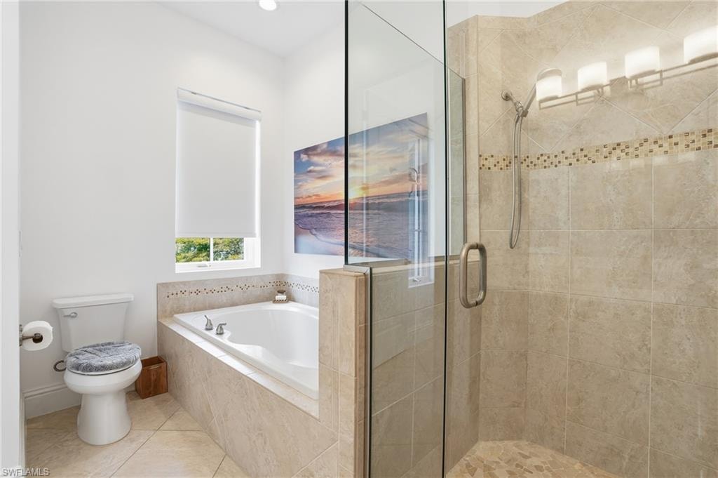 Bathroom with a shower stall, tile patterned floors, a bath, and recessed lighting