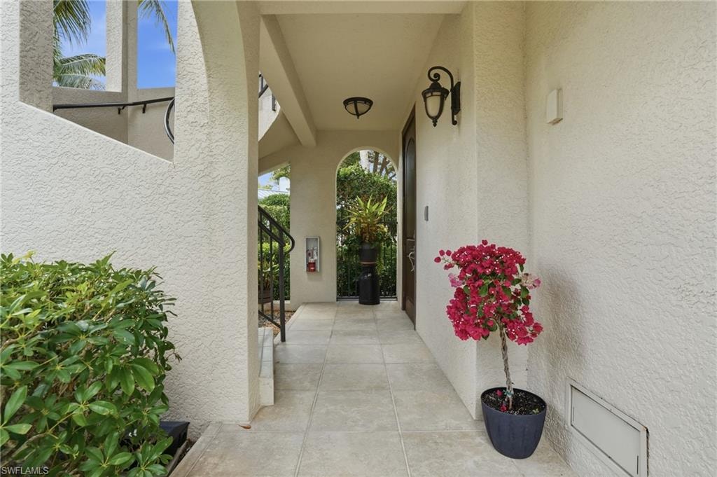 Entrance to property featuring stucco siding and a patio