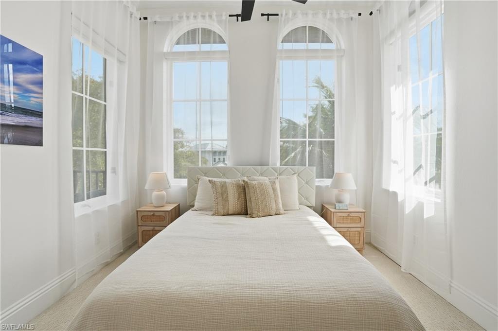 Bedroom featuring light colored carpet and baseboards