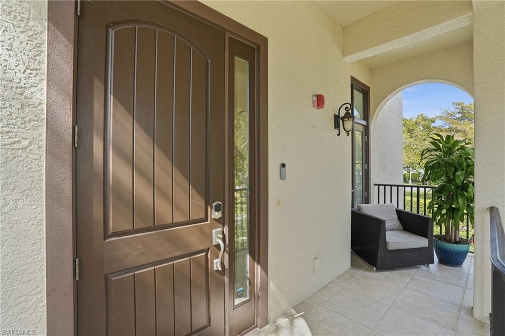 Property entrance featuring stucco siding