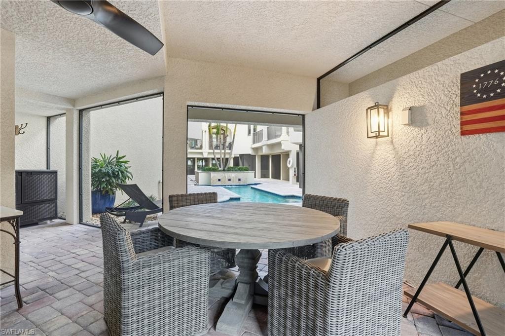 View of patio / terrace featuring outdoor dining area and an outdoor pool