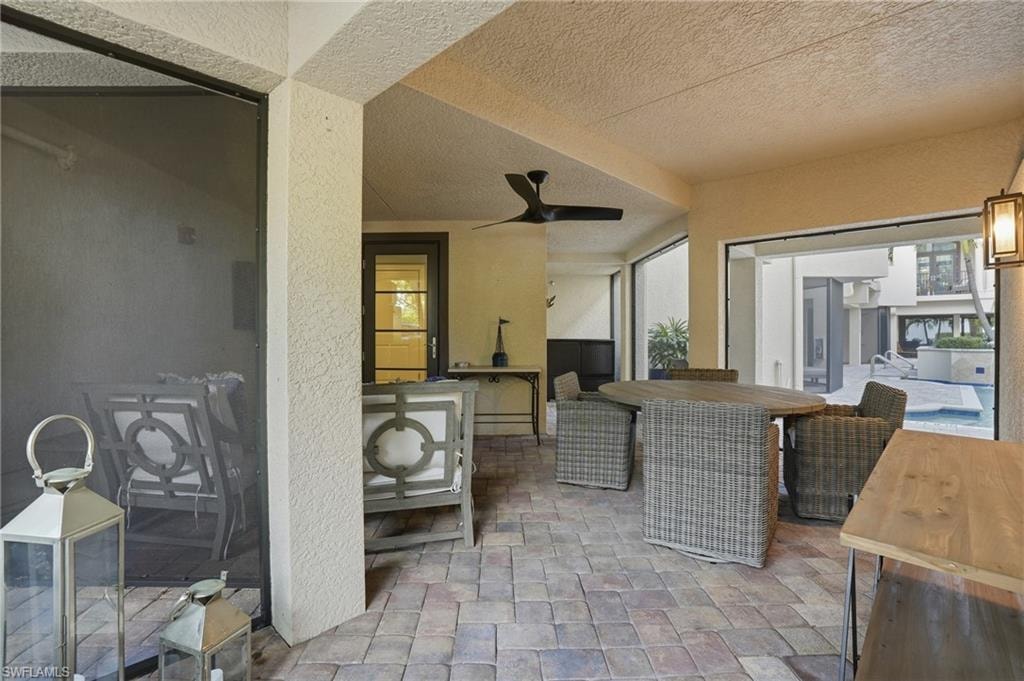 View of patio featuring a ceiling fan and an outdoor bar and dining area