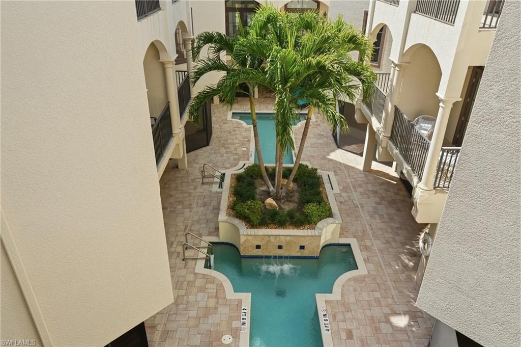 Community pool featuring a patio area and a balcony