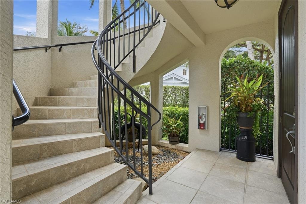 Entrance foyer featuring healthy amount of natural light, tile patterned flooring, and a textured wall