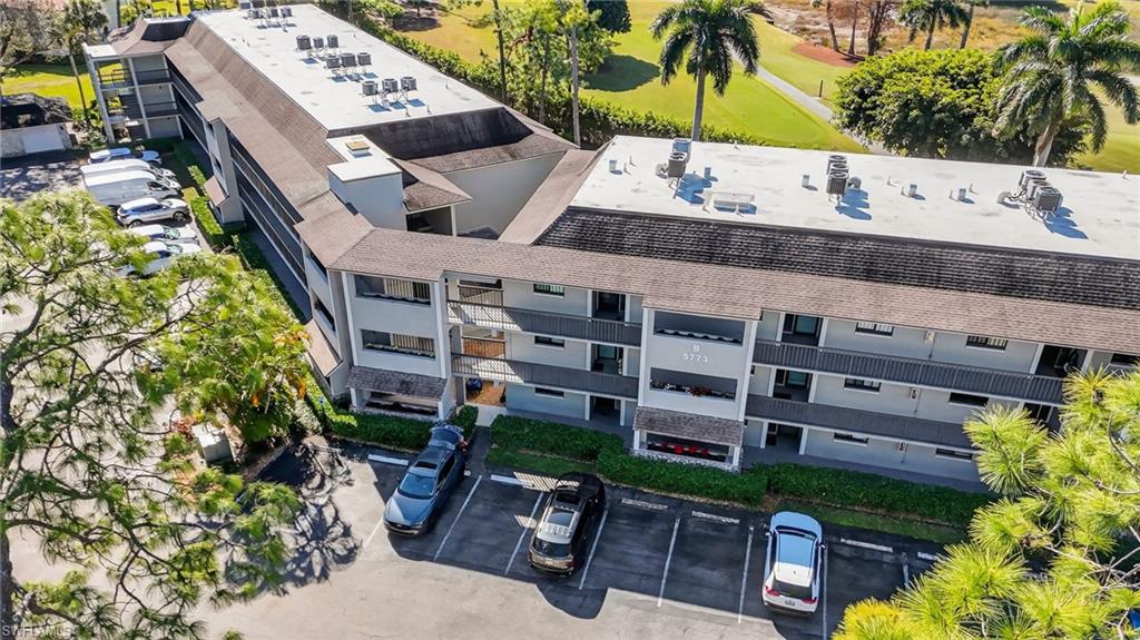 Aerial view of condo complex / building and a golf course