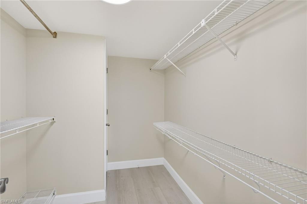 Walk in closet featuring light vinyl finished floors