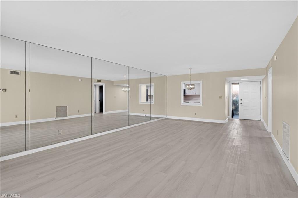 Empty room featuring light vinyl finished floors and baseboards