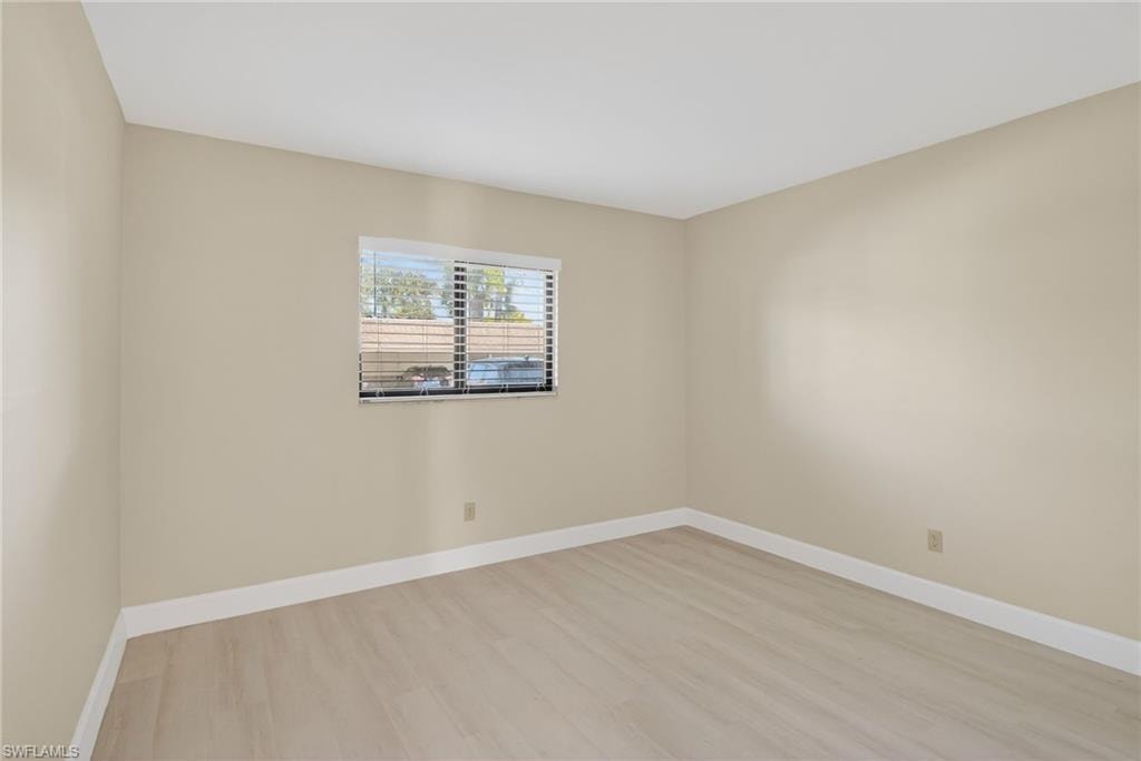Empty room with baseboards and light vinyl-type flooring