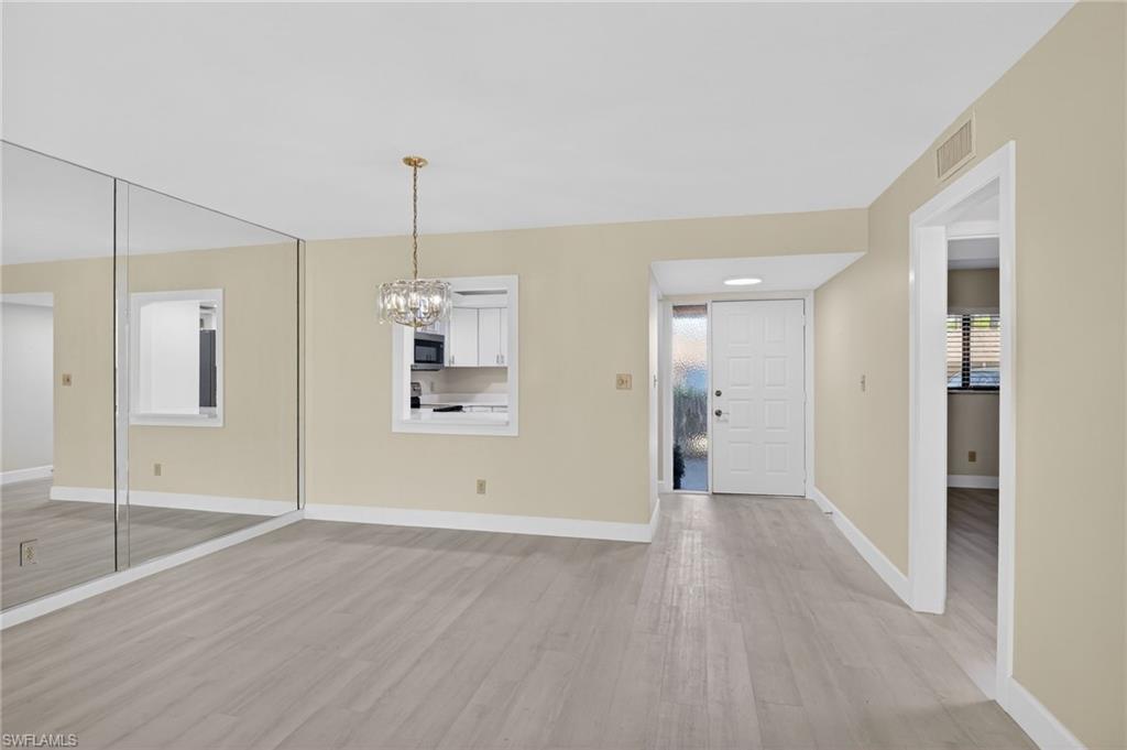 dining area with light vinyl-style flooring and a chandelier