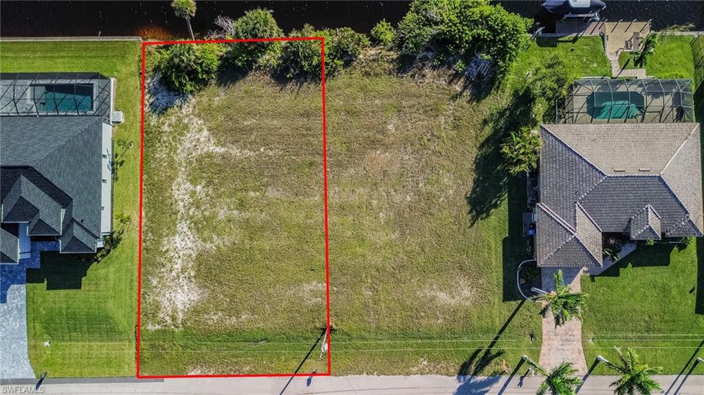 Aerial view of property and surrounding area with property parcel outlined