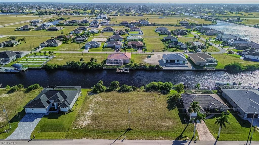 Aerial perspective of suburban area featuring a large body of water
